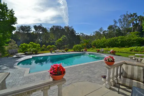 Concrete paver pool deck wrapping a freeform pool on a Rancho Santa Fe project